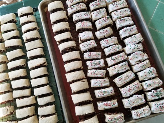 Rows of freshly baked cookies with colorful sprinkles.