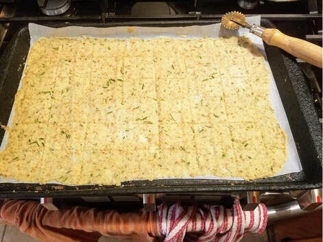 Baked herb and cheese flatbread on a tray.