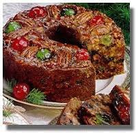 A festive fruitcake decorated with nuts and cherries.