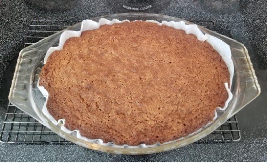 A freshly baked pie with a golden-brown crust in a baking dish.