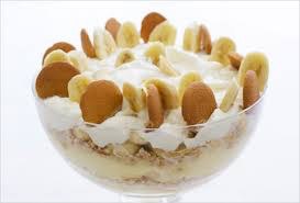 A creamy banana pudding dessert topped with vanilla wafers and whipped cream.