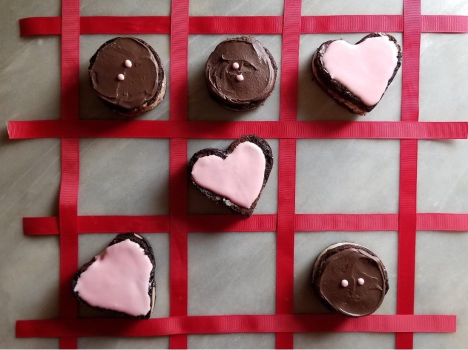 Delicious heart and bird-shaped cookies on elegant plates.