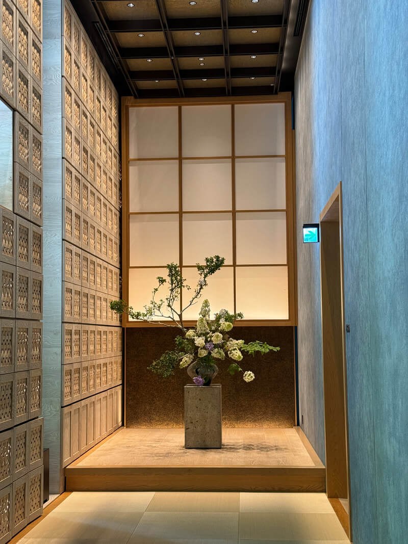Minimalist flower arrangement in a serene, softly lit space.