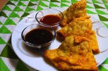 Golden fried samosas served with tamarind and mint chutneys.