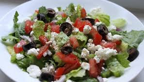 Fresh salad with olives, tomatoes, and feta cheese.
