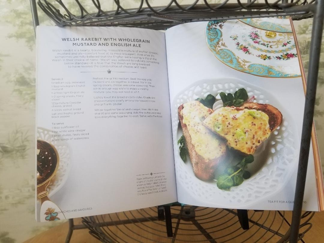 Open cookbook showing a recipe for spinach and artichoke melt with a plated dish.