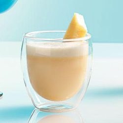 A creamy coffee drink in a double-walled glass with a pineapple garnish.