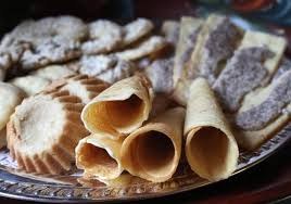 Assorted traditional cookies and wafer cones on a platter.
