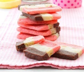 Colorful layered ice cream cookies on a pink cloth.