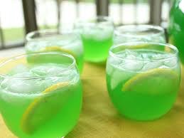 Glasses of refreshing green lemonade with lemon slices and ice cubes.