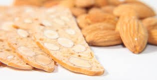 Close-up of almond biscotti with a blurred background of pastries.