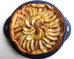 A freshly baked apple tart with neatly arranged apple slices.