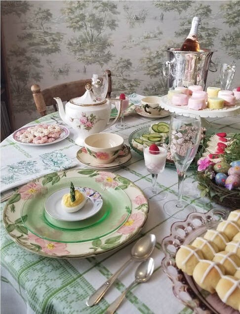 Elegant tea party setup with fine china and assorted sweets.