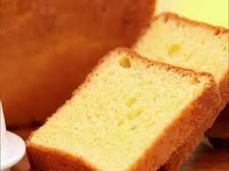 Close-up of a sliced loaf of golden, fluffy bread.