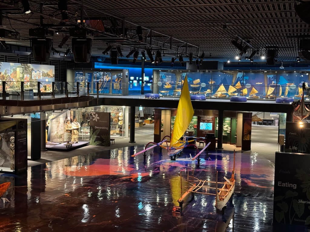 A museum interior with various exhibits and a large yellow sculpture.