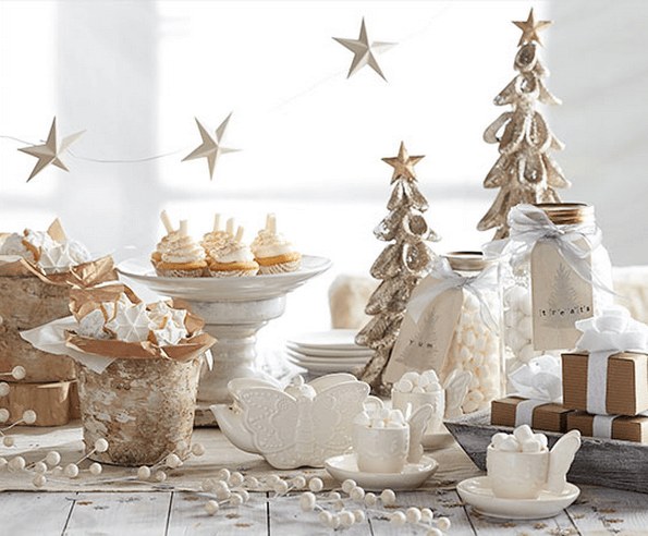 Elegant Christmas table setting with white and gold decorations.
