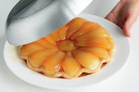 A pear tart with glossy pear slices on a pastry base.