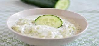 Creamy cucumber yogurt dip garnished with a cucumber slice.