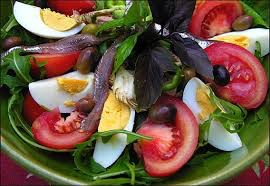 Fresh salad with eggs, tomatoes, and greens.