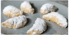 Powdered sugar crescent cookies on a baking sheet.