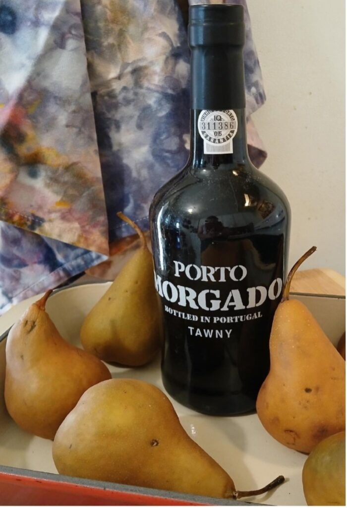 A bottle of Porto Morgado Tawny wine surrounded by pears.