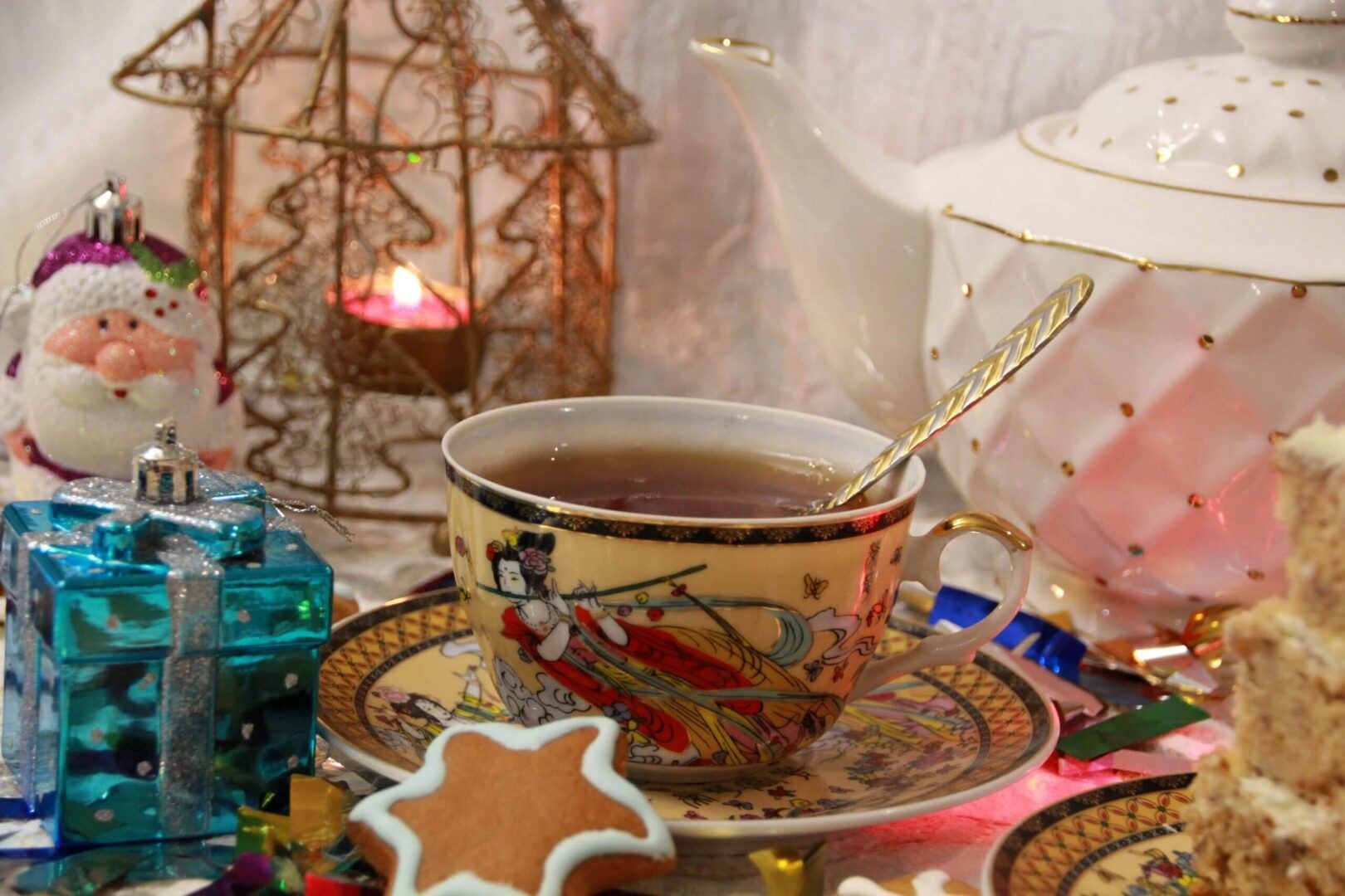 A decorative cup of tea with a star-shaped cookie on a vibrant tray.