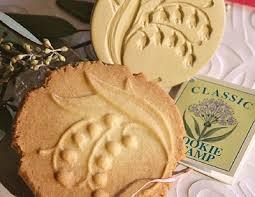 Decorative round cookies with floral impressions and packaging.