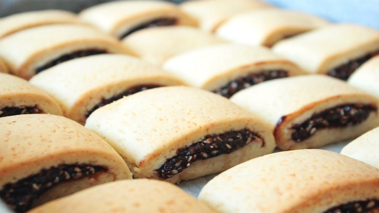 Rows of baked pastries filled with a chocolate filling.