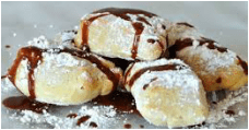 Pastries dusted with powdered sugar and drizzled with chocolate sauce.