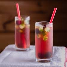 Two refreshing berry-infused drinks with ice and straws.