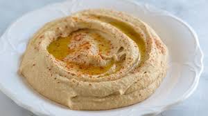 Creamy hummus drizzled with olive oil and sprinkled with paprika.