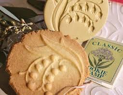 Round cookies with a leaf design and a stamp of grapes.