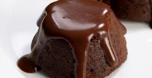 A close-up of a rich chocolate lava cake with melting chocolate on top.