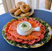 Smoked salmon platter with cream cheese and bagels on the side.