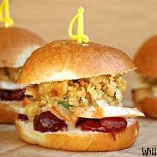 A sandwich with crispy fried filling and sauce in a soft bun.