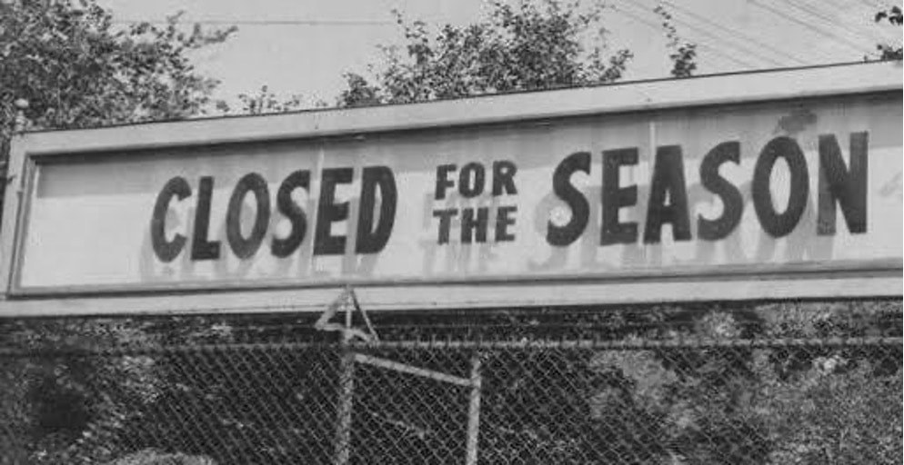 A sign reads 'Closed for the Season' above a fenced area.