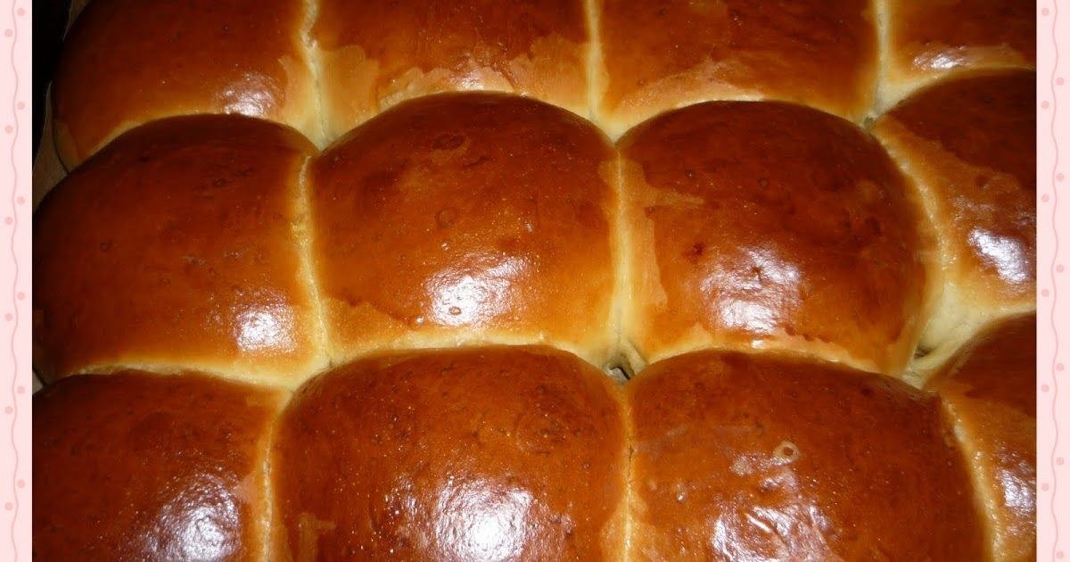 Golden brown bread rolls closely packed together.