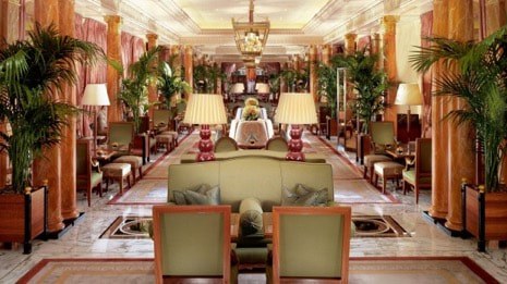 Elegant, lavishly decorated hotel lobby with classical furnishings and warm lighting.