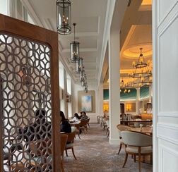 Cozy cafe interior with wooden decor and warm lighting.