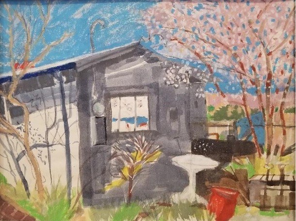 House by blooming trees under clear sky.