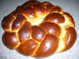 Golden braided bread with a shiny crust.