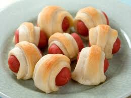 Mini pigs in a blanket with golden-brown pastry.