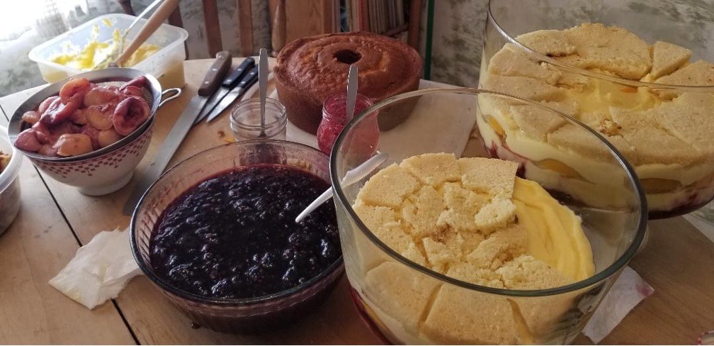 Close-up of corn chips, salsa, and a cake on a table.