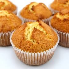 Golden-brown freshly baked muffins in white paper liners.