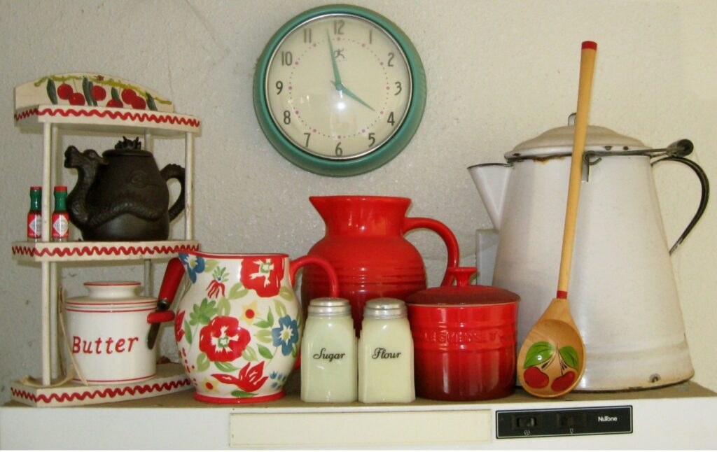 Vintage kitchenware with clock and decorative items.