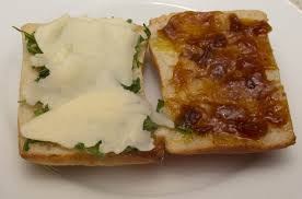Open sandwich with mashed potatoes and melted cheese topping.