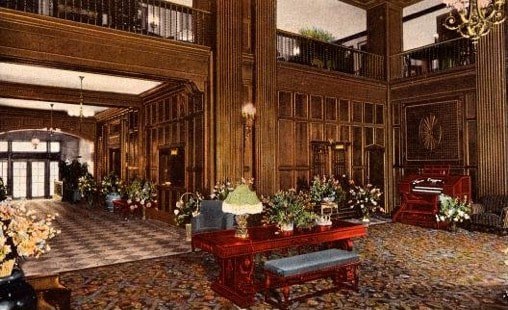 Elegant hotel lobby with floral arrangements and classic decor.