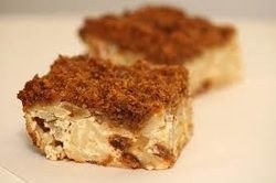 Two pieces of crumb-topped dessert bars with nuts.