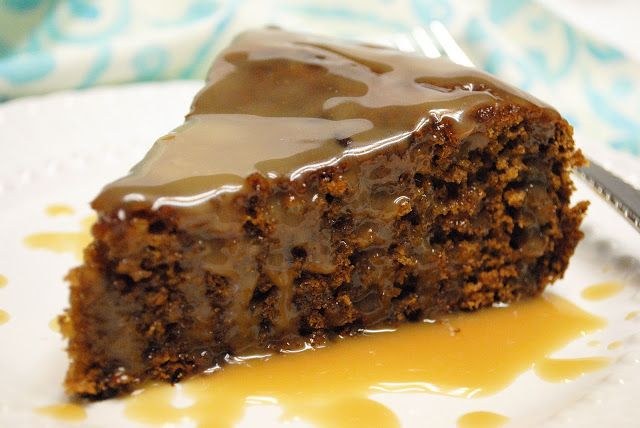 Slice of rich chocolate cake drizzled with caramel sauce.