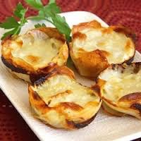 Baked stuffed mushrooms topped with melted cheese and herbs.